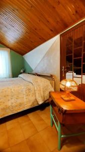 a bedroom with a bed and a table with a lamp at Casa alla Costa in Mormanno