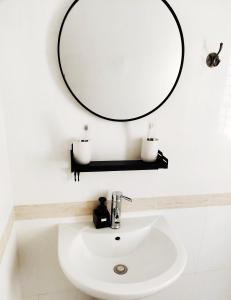 a bathroom with a sink and a mirror at 闲肆民宿 in Sanya