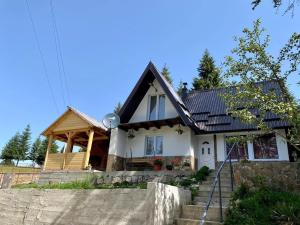 a house with a black roof at Vikendica Amra i Indir in Travnik