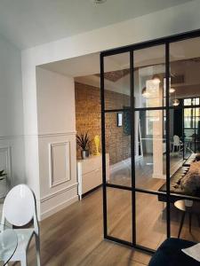 a living room with glass doors and a dining room at Lux apartment near Wawel in Krakow