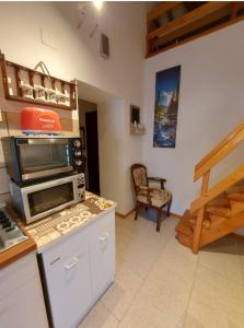 a kitchen with a microwave oven on a counter at Casa Lorenzo - nel centro storico di Fiumalbo in Fiumalbo