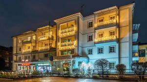 a large white building with lights in front of it at Hotel Garni Lichtquelle in Bad Füssing