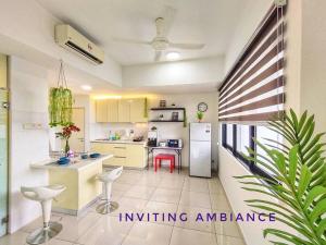 a kitchen with a refrigerator and a table and chairs at Urban-Nature Retreat Encorp Strand Alpha IVF 3px in Petaling Jaya