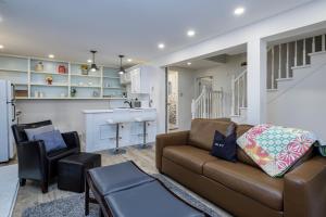 a living room with a couch and a kitchen at The Elizabeth Manor Guesthouse in St. John's