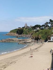 un grupo de personas en una playa cerca del océano en les pieds dans l'eau à 50 mètres de la mer, en Saint-Quay-Portrieux