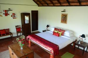 a bedroom with a large bed and a table and chairs at Paradisa Nature Resort in Pīrmed
