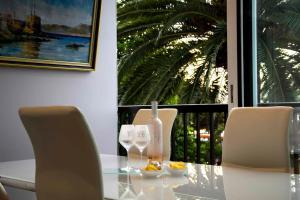 a glass table with two chairs and a window at Sérénité Marines ‣Incredible Sea view in Saint-Tropez