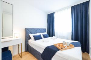 a bedroom with a bed with a tray of food on it at Alpha Level Apartment in Zadar