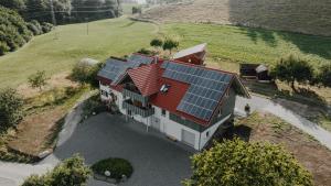 an aerial view of a house with solar panels on it at BodenSEE Apartment Neukirch Goppertsweiler FUCHS in Neukirch