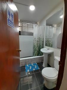 a bathroom with a toilet and a sink at AKAO HOUSE in Arequipa