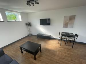 a living room with a couch and a table at Spacious 1 bedroom apartment in Bolsover in Chesterfield