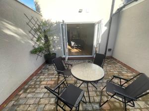 a patio with a table and chairs on a patio at Ideal family apartment in Bolsover sleeps 4 in Chesterfield