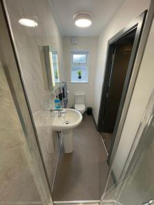 a bathroom with a sink and a toilet at Ideal family apartment in Bolsover sleeps 4 in Chesterfield