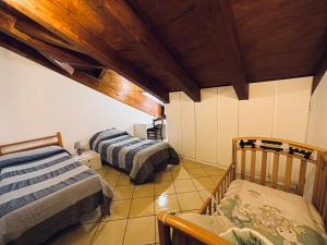 a attic room with two beds and wooden ceilings at Home Sweet Home Apartment in Agerola