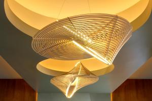 a large metal light fixture hanging from a ceiling at Hotel Zelos San Francisco in San Francisco