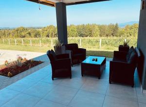 a patio with chairs and a table and a view at Vikendica Fenix in Banja Luka
