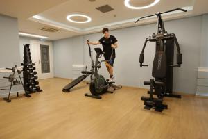 a man exercising on a treadmill in a gym at Paliria Hotel in Chalkida