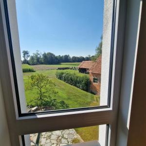 a window with a view of a green field at Ferienwohnung Ruß in Bad Radkersburg