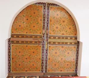 an ornate wooden door in a building at Ryad 91 in Casablanca