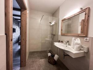 a white bathroom with a sink and a mirror at Gmundnerberghaus in Altmünster