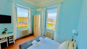 a bedroom with a bed and two large windows at B&B - Residenza d'epoca Piazza Cairoli in Pisa