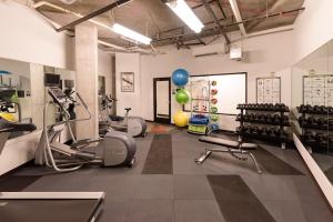 a gym with treadmills and exercise equipment in a room at One bedroom luxury apartment (Gym, Wifi, Parking, Rooftop Deck) in Seattle