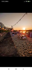 a beach with a group of chairs and the sunset at NightHost - Kleczkowska 49 in Wrocław