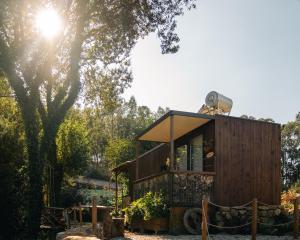 a tiny house in a garden with a tree at Bruval Eco Retreat in Sandim