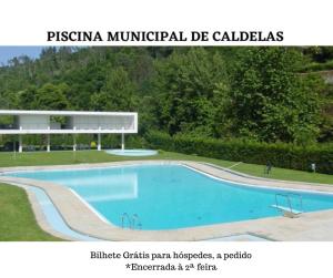 a picture of a swimming pool with a sign for a building at Eirado Hotel in Caldelas