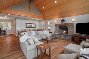 a living room with a couch and a fireplace at Five Peaks Home with Soaking Tub in Bend