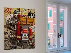 a painting of a red scooter next to a window at La Grotta dei Cinque Sensi in Vernazza