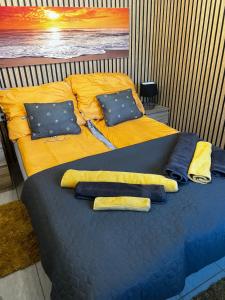 a blue bed with towels and pillows on it at Füle-Müle Élményház in Füle +28 photos