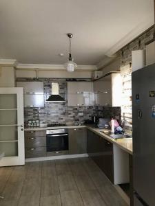 a large kitchen with stainless steel appliances in a room at Ultra lüx Klimalı Daire in Trabzon