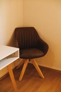 a black chair sitting next to a desk at Marty's corner in Livade