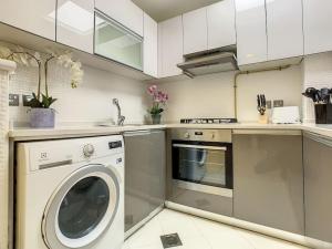 a kitchen with a washing machine and a dishwasher at Key View - Glitz 3, Tower 2 in Dubai
