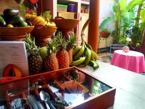 a display of pineapples and bananas on a counter at Hotel La Polvora in Granada
