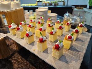 a group of desserts on a wooden table at Lloret Vibe Affiliated by FERGUS in Lloret de Mar