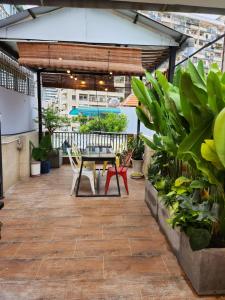 a patio with a table and chairs and plants at HALF Coffee N Dorm in Ho Chi Minh City