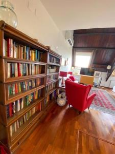 a room with a large book shelf filled with books at Passeig de Gracia Studio Loft in Barcelona