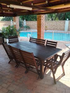 a black picnic table with four chairs around it at Just B Zone Guest House in Johannesburg