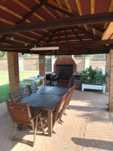 a wooden table and chairs on a patio at Just B Zone Guest House in Johannesburg