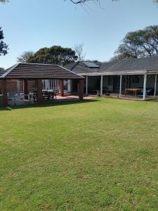 a house with a large lawn in front of it at Just B Zone Guest House in Johannesburg