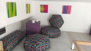 um quarto com dois repousa-pés e duas cadeiras em Cozy Gallery - City Centre em Novi Sad