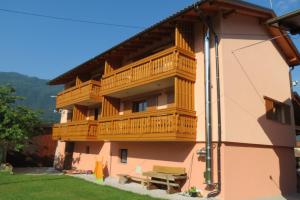 a building with a balcony on the side of it at Apartments Masera in Kobarid