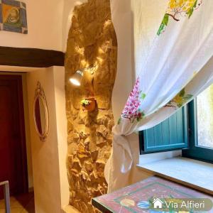 a room with a stone wall and a window at Casa centro storico borgo medievale in San Mauro Castelverde