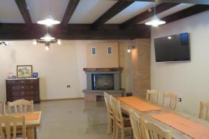 a dining room with a table and a fireplace at Apartments Masera in Kobarid
