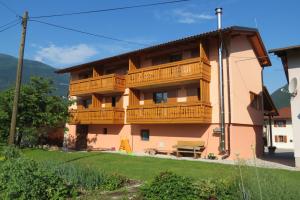 a building with a balcony on the side of it at Apartments Masera in Kobarid