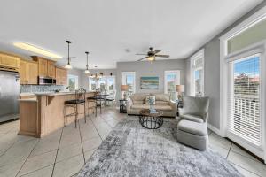 a kitchen and living room with a couch and a table at Seashine and Sunkises - Great pricing near Seaside in Santa Rosa Beach