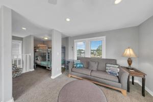 a living room with a couch and a table at Seashine and Sunkises - Great pricing near Seaside in Santa Rosa Beach +28 photos
