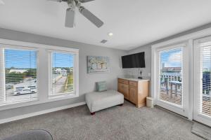 a room with a desk and a tv and windows at Seashine and Sunkises - Great pricing near Seaside in Santa Rosa Beach